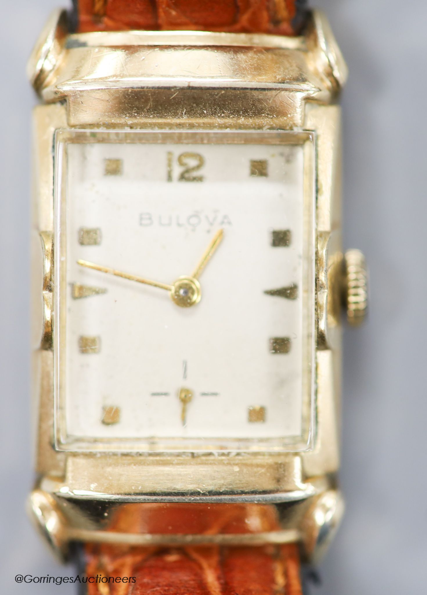 A gentleman's 1930's 10k rolled gold Bulova manual wind rectangular dial wrist watch, with subsidiary seconds, on later leather strap.